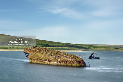 The Churchill Barriers with the wreck of the SS Reginal Blockship in Orkney, Scotland.
