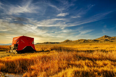 Scuba divers set up this tent with the beautiful view of the surrounding mountains and marsh area.