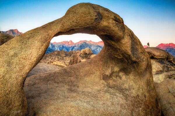 Mobius Arch with Mt. Whitney and hiker on faraway rock