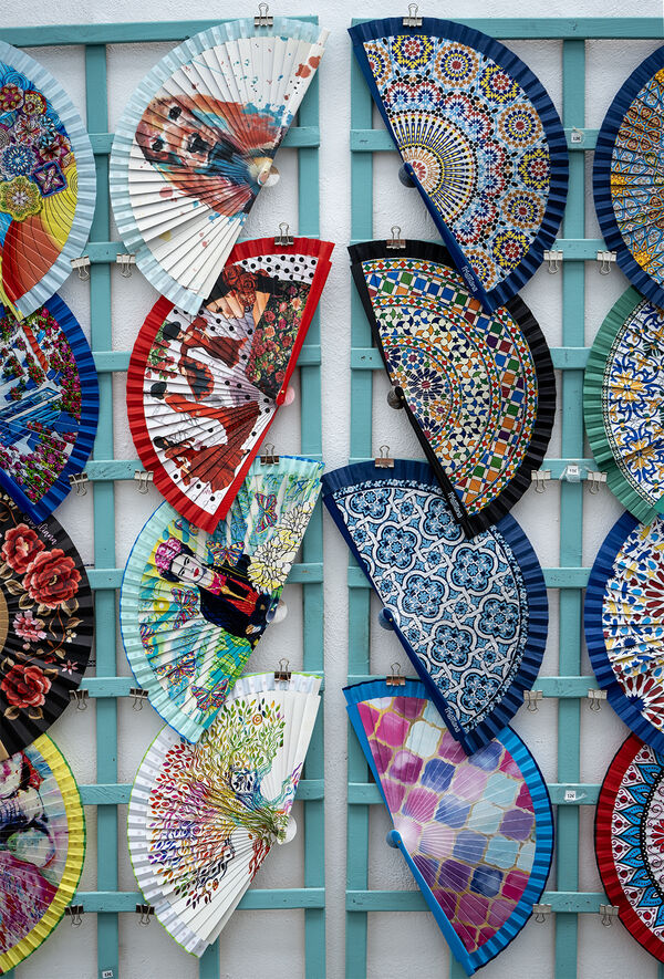 A lot of small shops in the historic part of Frigiliana lies, along the "Calle Real", sells items tourists and locals cant live without. Here fans are for sale. 
Might be handy in the hot summer months.