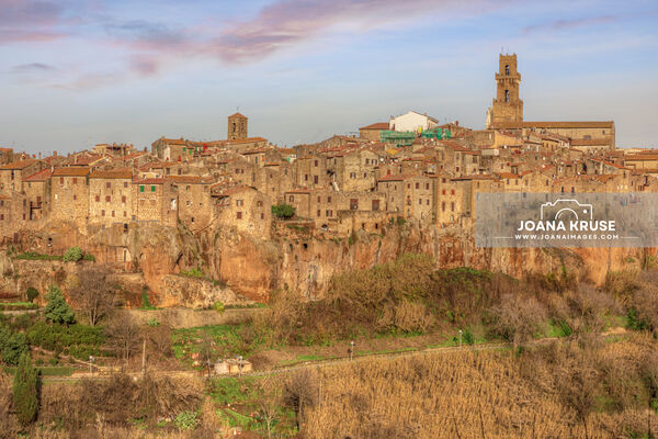 Pitigliano in the Maremma region of Tuscany is a stunner, perched atop a dramatic tuff stone cliff. The town's buildings have stood the test of time, creating a vertical wall of ancient structures above the deep drop of the tuff stone. The texture of the very old houses is amazing.

