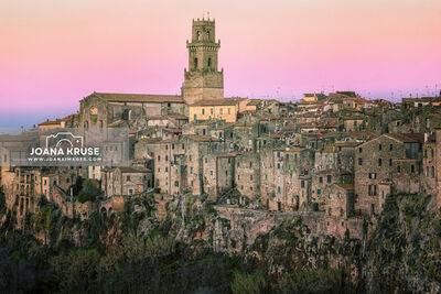 Pitigliano in the Maremma region of Tuscany is a stunner, perched atop a dramatic tuff stone cliff. The town's buildings have stood the test of time, creating a vertical wall of ancient structures above the deep drop of the tuff stone. The texture of the very old houses is amazing.