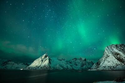 Nighttime’s Northern lights over the mountains.