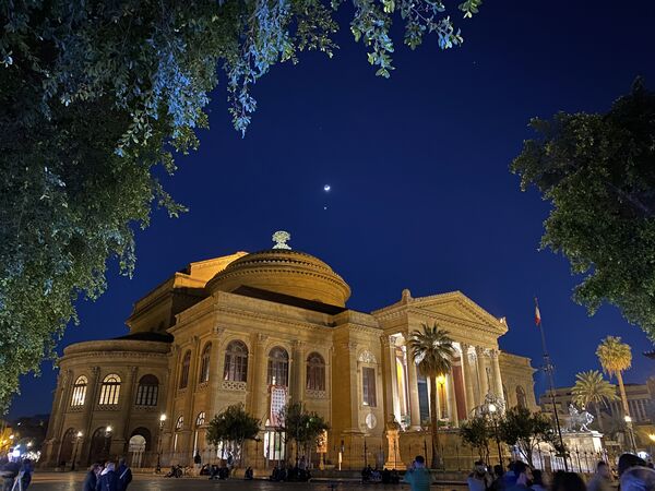 View of the Teatro Massimo in Palermo, one of the largest theaters in Europe. This photo was taken towards the end of April last year at 8.41pm during the blue hour and there was the moon clearly visible right above the monument. Don't judge the quality of the image (this photo was taken with a humble iPhone 11 Pro) but take inspiration from an unusual point of view.