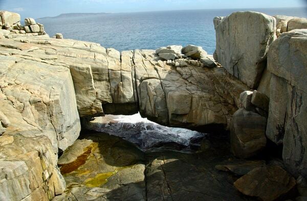The Natural Bridge is a granite formation that looks just like a giant rock bridge! This 'bridge' is caused by the gradual wearing away of the granite rock by the Great Southern Ocean.