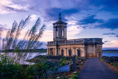 The breathtaking Normanton Church stands like a majestic castle amidst the tranquil waters of Rutland Lake, seemingly suspended in mid-air as the sun sets behind it. Originally known as St. Matthews Church, this iconic building is now a sought-after wedding venue and one of Rutland's most recognizable landmarks. The church's striking architecture and stunning surroundings make it the perfect location for romantic ceremonies and outdoor photoshoots.