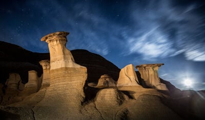 Hoodoos with a full moon. The light on them is from a powerful flashlight and light painting. 