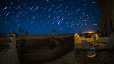 Multiple exposures to capture the star trails and light painting done in the foreground and masked in with layers in PS.